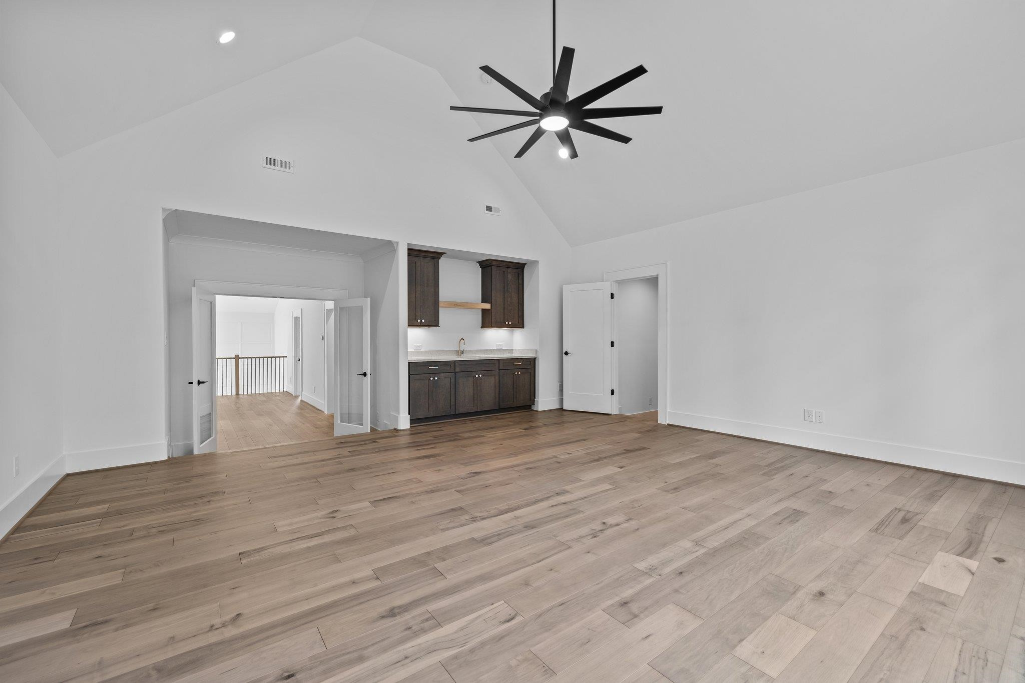 7605 Harps Mill Road Raleigh, NC 27615 - Photo 53 of 70 a view of empty room with wooden floor and ceiling fan