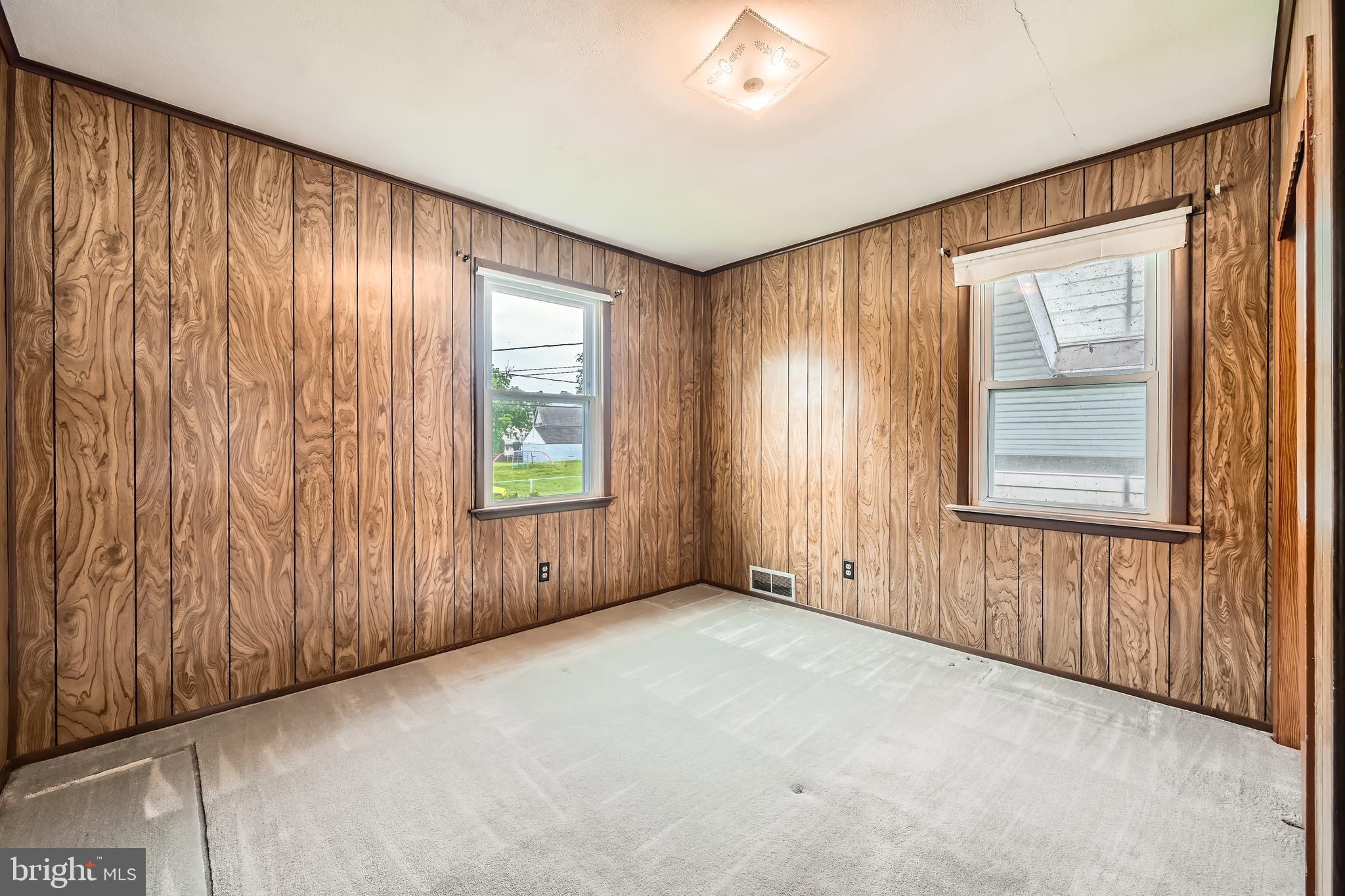 6805 River Drive Road Baltimore, MD 21219 - Photo 12 of 28 an empty room with windows