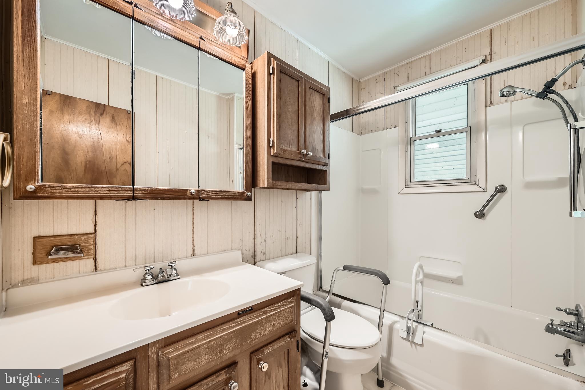6805 River Drive Road Baltimore, MD 21219 - Photo 13 of 28 a bathroom with a sink and a mirror