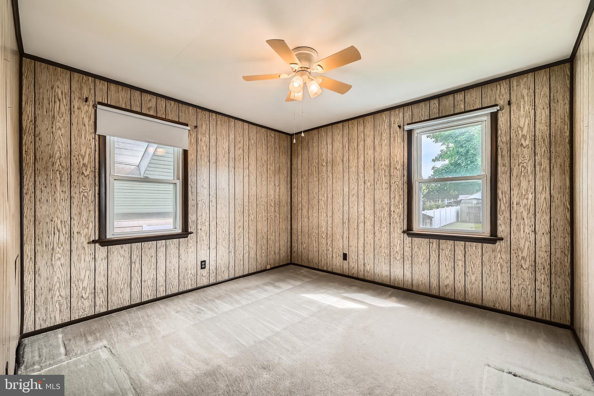 6805 River Drive Road Baltimore, MD 21219 - Photo 15 of 28 an empty room with windows and fan