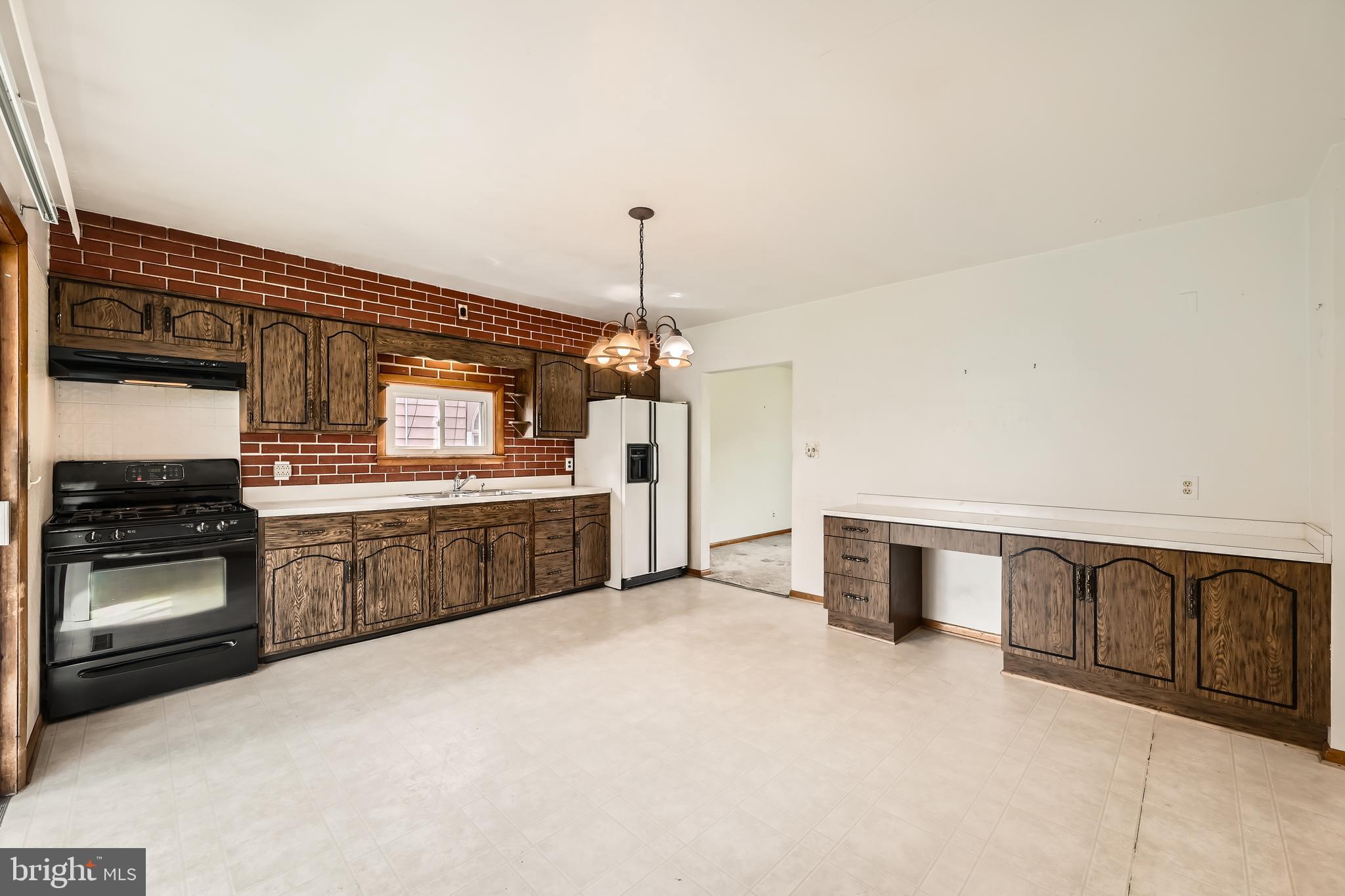 6805 River Drive Road Baltimore, MD 21219 - Photo 9 of 28 a kitchen with stainless steel appliances granite countertop a sink and stove top oven