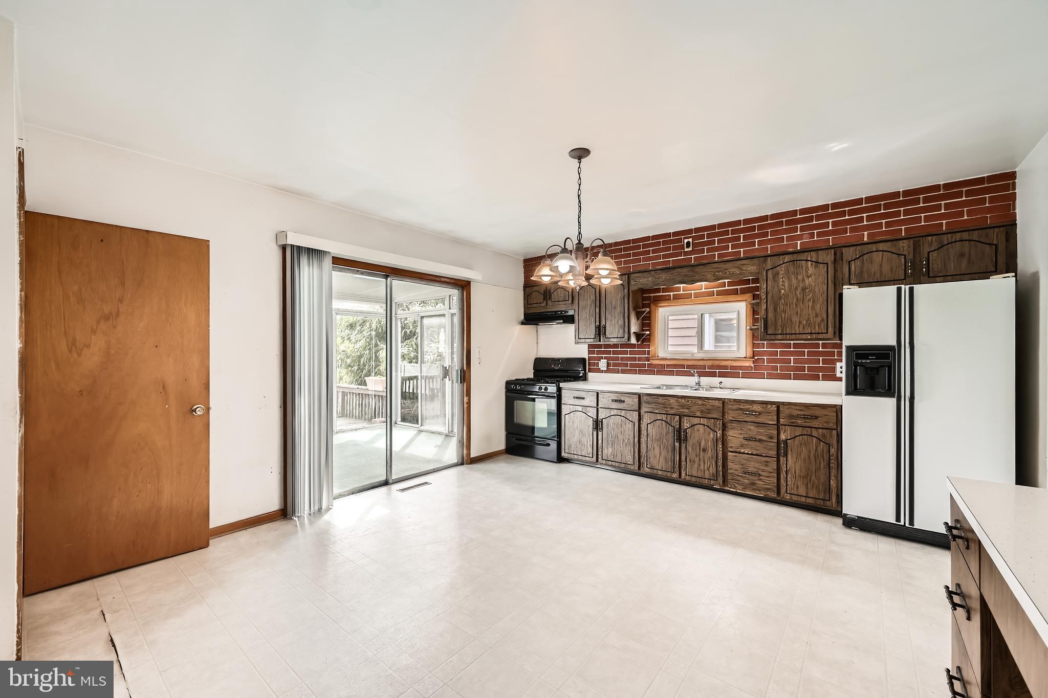 6805 River Drive Road Baltimore, MD 21219 - Photo 10 of 28 a large kitchen with kitchen island a sink stainless steel appliances and cabinets