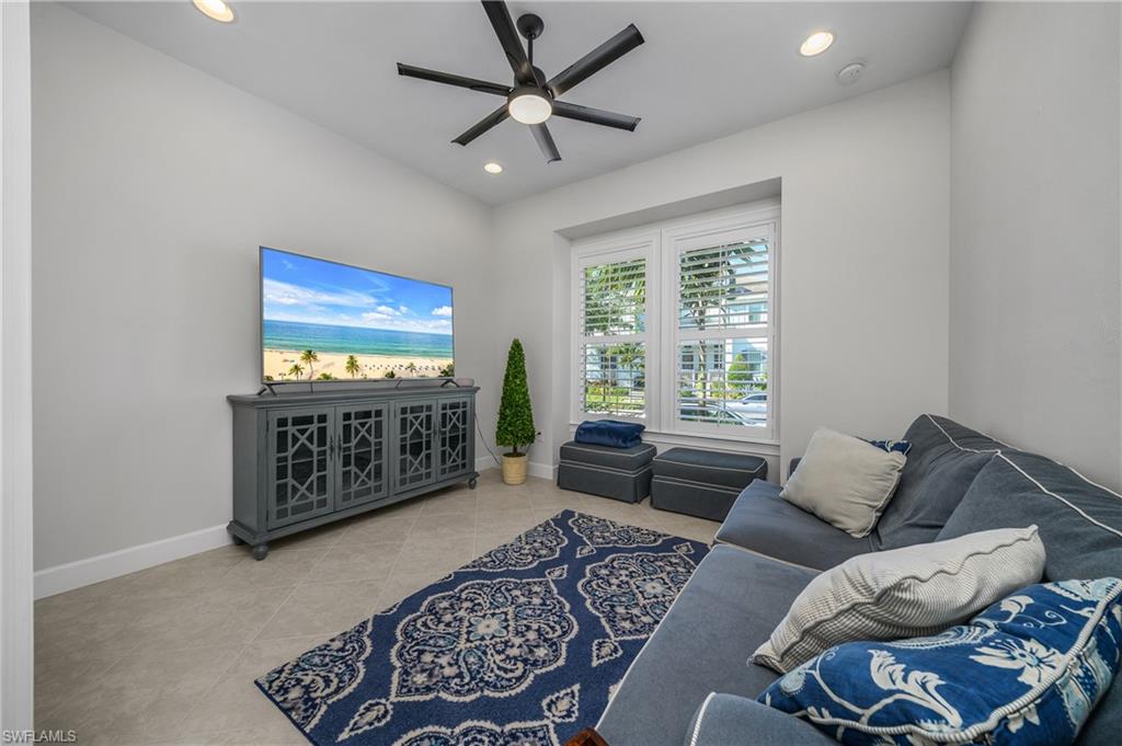 6552 Dominica Drive, Unit 101 Naples, FL 34113 - Photo 24 of 50 a living room with furniture a rug and a window
