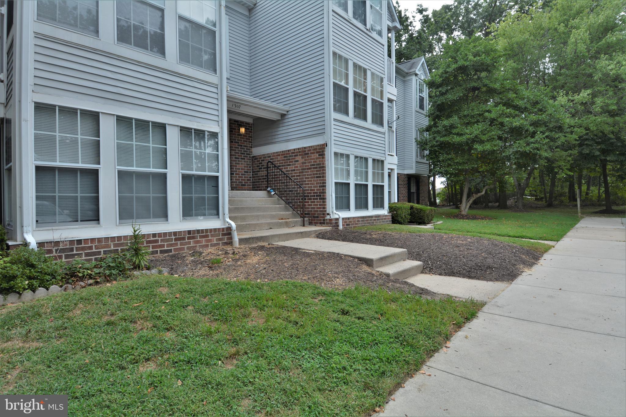 1307 J Clover Valley Way, Unit 1307J Edgewood, MD 21040 - Photo 2 of 25 a front view of a house with garden