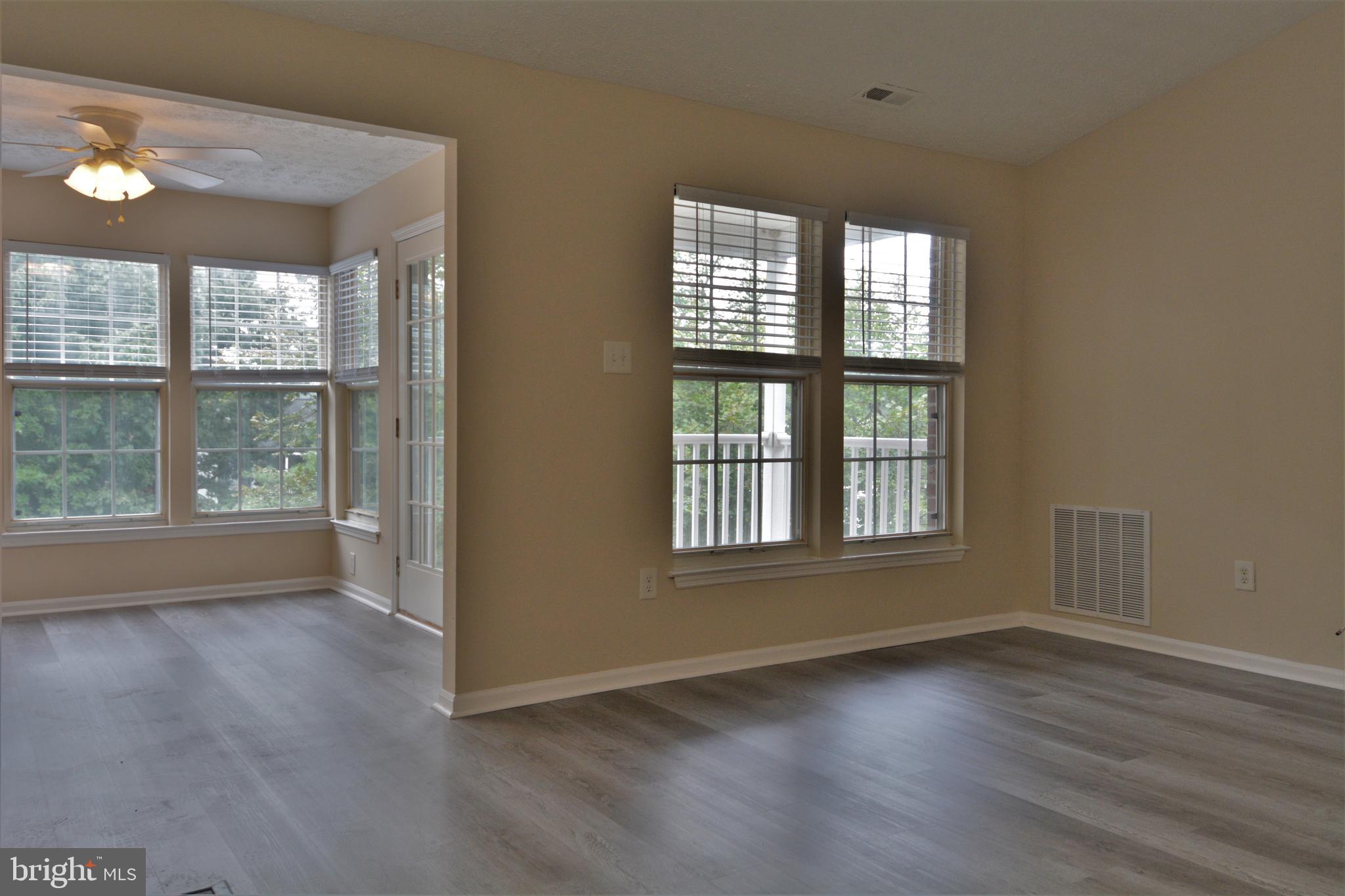 1307 J Clover Valley Way, Unit 1307J Edgewood, MD 21040 - Photo 4 of 25 an empty room with wooden floor and windows