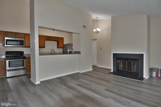 a kitchen with stainless steel appliances granite countertop a sink stove and microwave