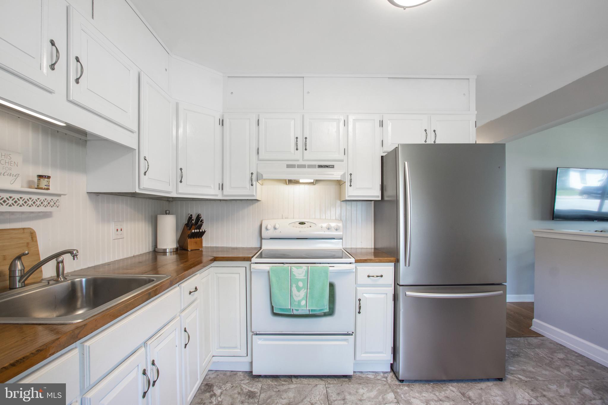 205 South Longcross Road Linthicum Heights, MD 21090 - Photo 11 of 57 a kitchen with stainless steel appliances a refrigerator a sink and a stove