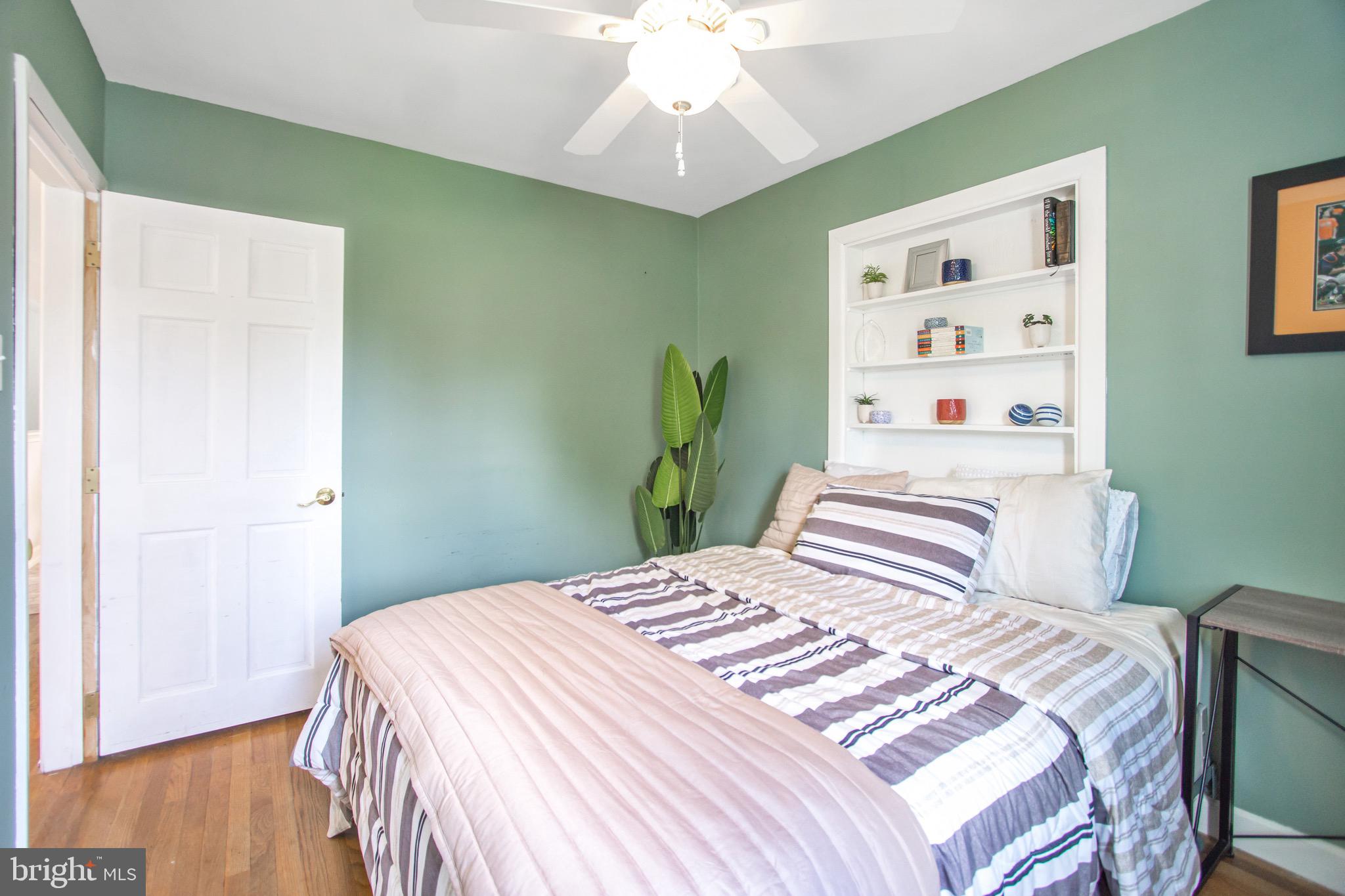 205 South Longcross Road Linthicum Heights, MD 21090 - Photo 29 of 57 a bedroom with a bed and a chandelier