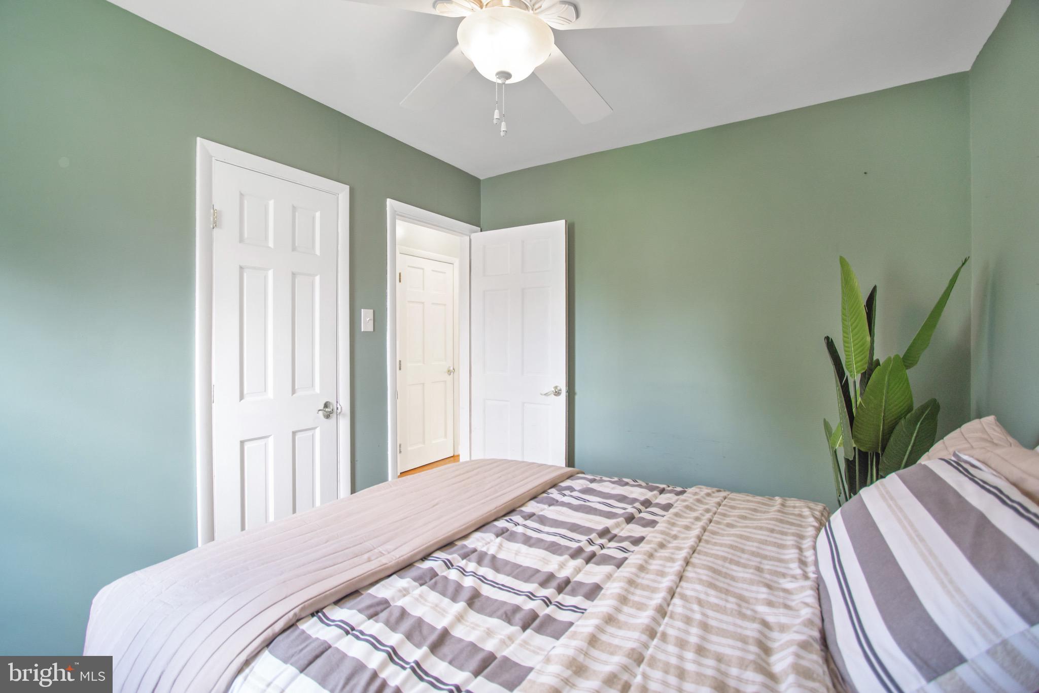 205 South Longcross Road Linthicum Heights, MD 21090 - Photo 30 of 57 a bedroom with a bed and a potted plant