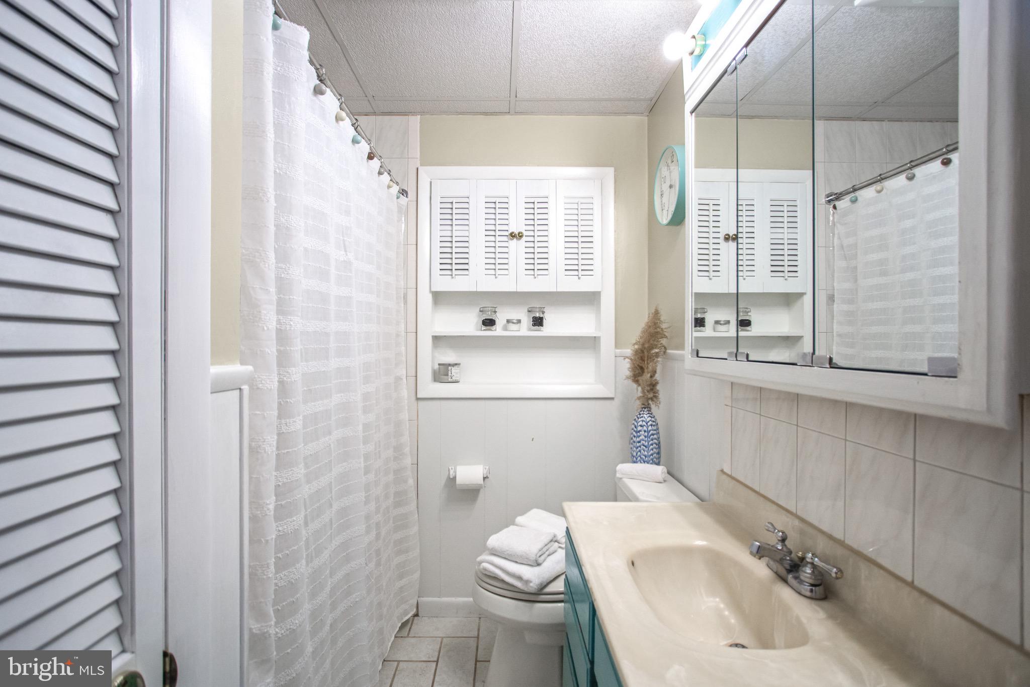 205 South Longcross Road Linthicum Heights, MD 21090 - Photo 32 of 57 a bathroom with a sink a toilet and shower