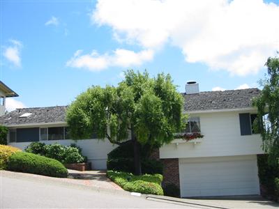 a front view of a house with a yard and a garage