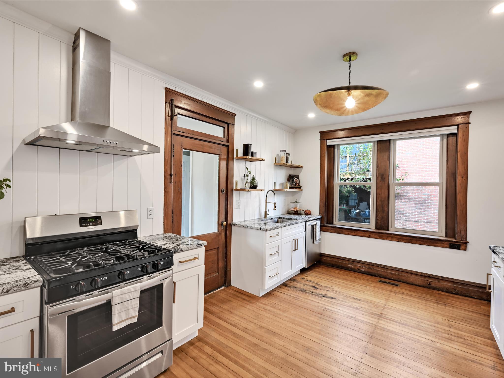 28 Charles Road Lancaster, PA 17603 - Photo 12 of 45 a large kitchen with stainless steel appliances granite countertop a stove and a wooden floors
