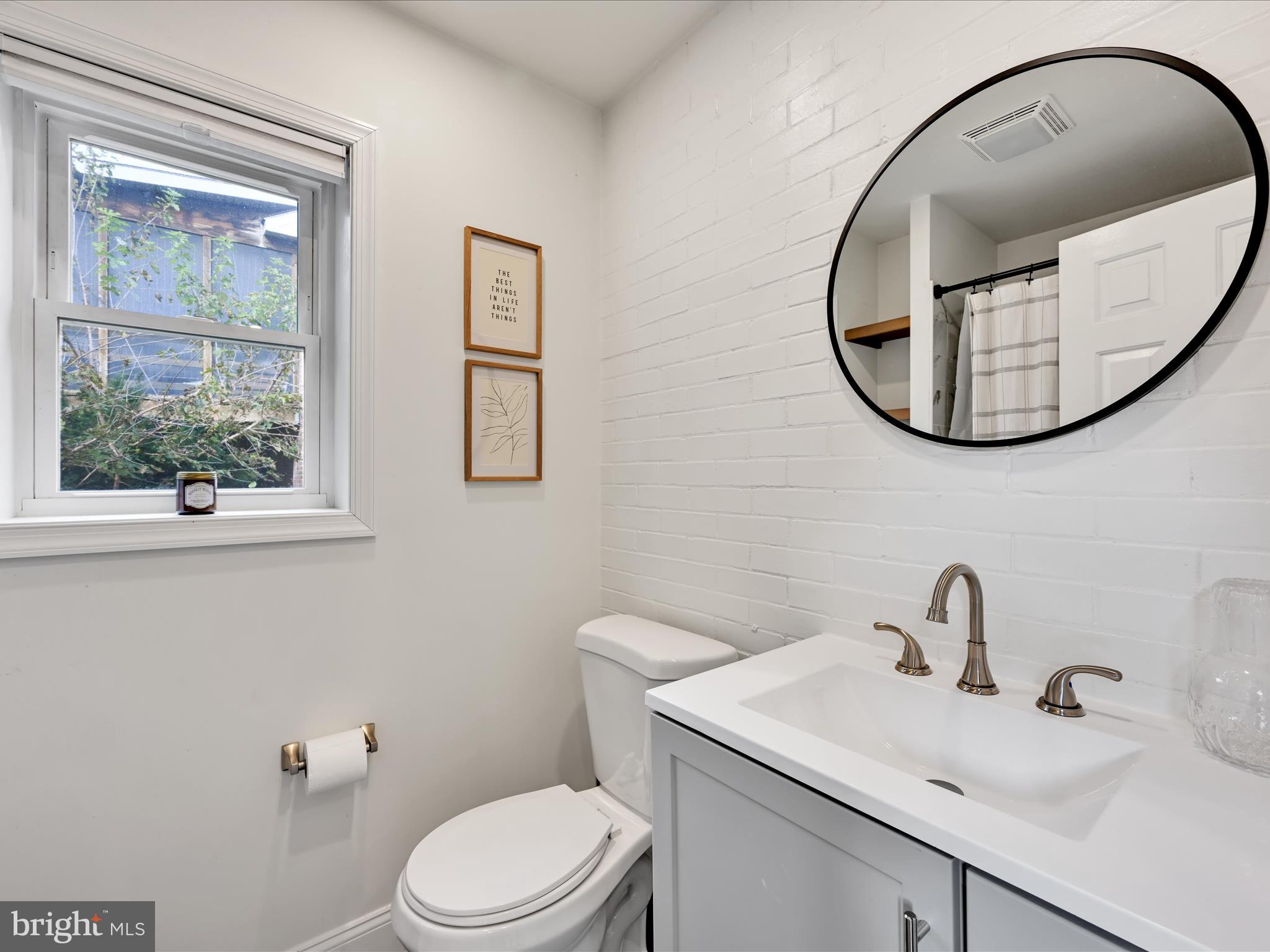 28 Charles Road Lancaster, PA 17603 - Photo 17 of 45 a bathroom with a toilet sink and mirror