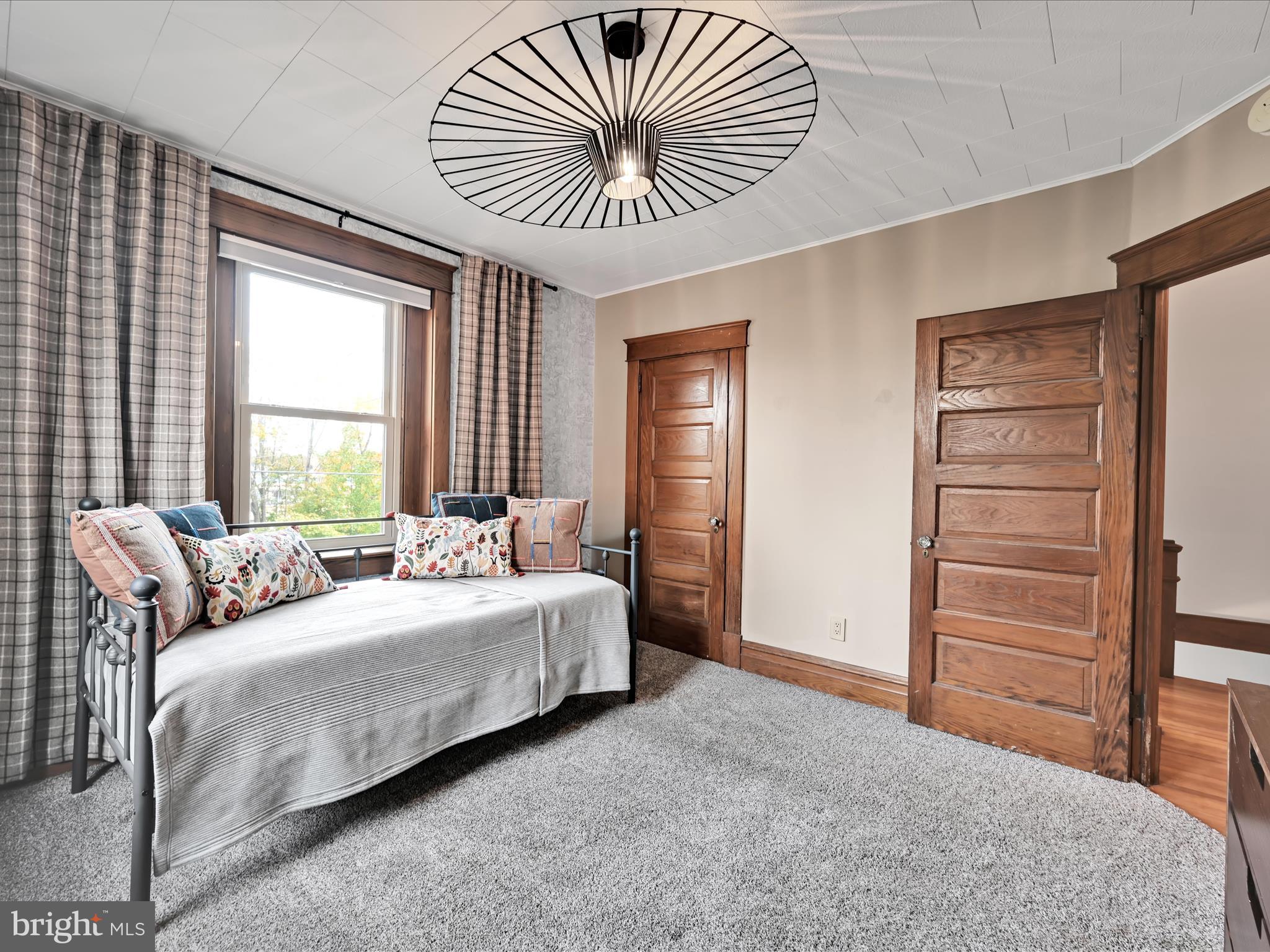 28 Charles Road Lancaster, PA 17603 - Photo 22 of 45 a bedroom with a bed and a chair