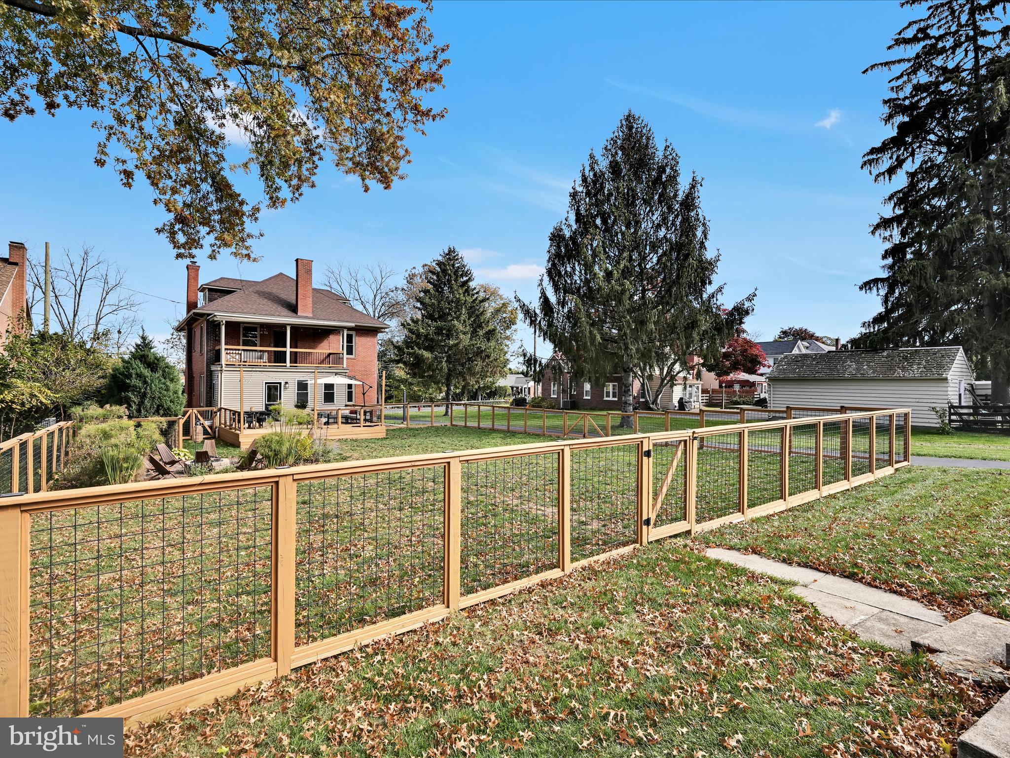 28 Charles Road Lancaster, PA 17603 - Photo 36 of 45 a view of a house with a small yard and wooden fence