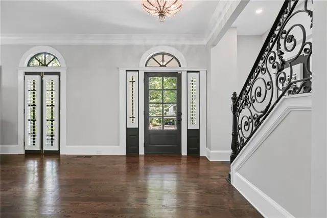 a view of an entryway with wooden floor