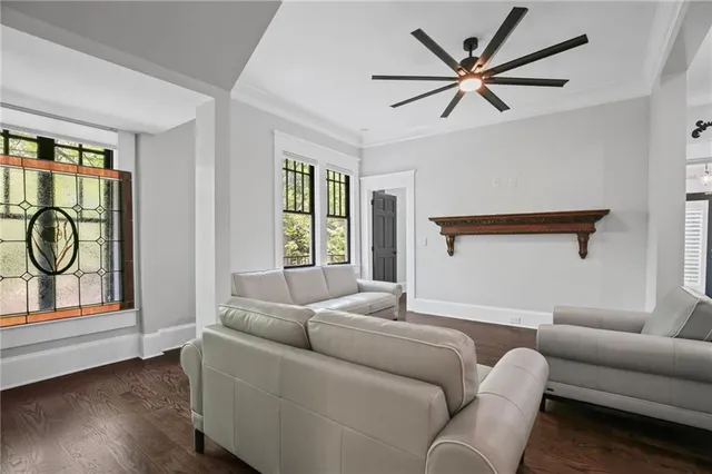 a view of a livingroom with wooden floor and chandelier