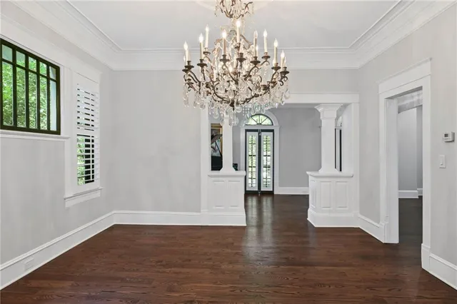 a kitchen with granite countertop a stove a sink and chandelier