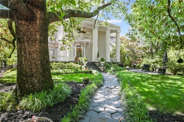 a view of a backyard with furniture and a garden