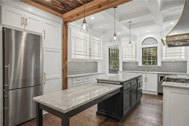 a bathroom with a granite countertop sink a window and a shower