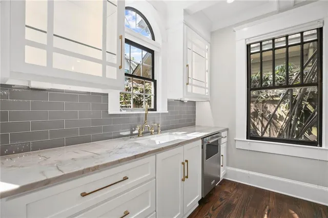 a view of a room with wooden floors and window