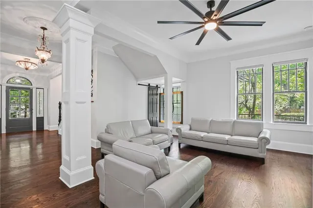 a view of a dining room with furniture a chandelier and wooden floor