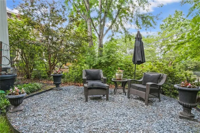 a front view of a house with potted plants