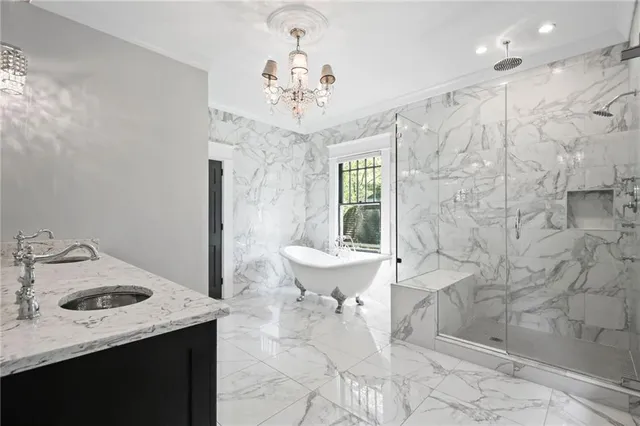 a view of a big room with wooden floor a ceiling fan and windows