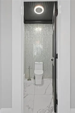 a spacious en suite bathroom with a toilet a mirror and a shower