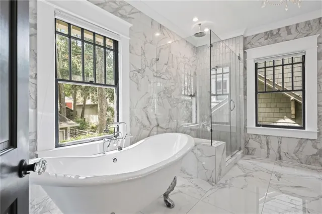 an empty room with wooden floor and a ceiling fan