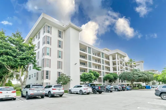 a city street lined with parked cars and buildings