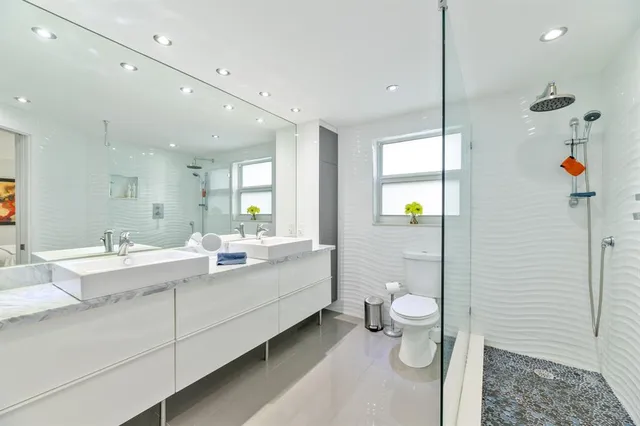 a bathroom with a toilet and a shower