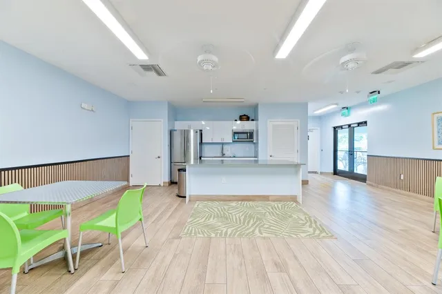 a view of a patio with plants and chairs