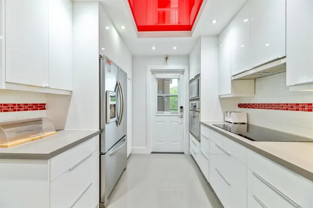 a group of people sitting in a kitchen