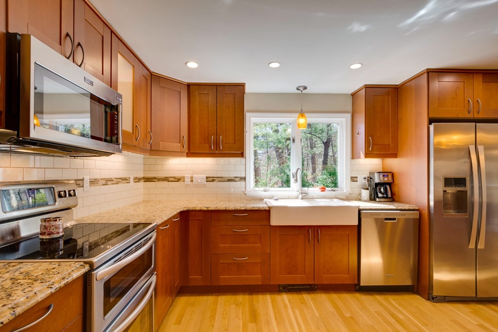 14 Highgate Street Needham, MA 02492 - Photo 11 of 27 a kitchen with granite countertop stainless steel appliances and wooden cabinets