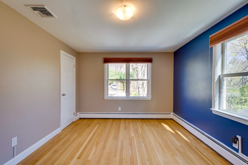 14 Highgate Street Needham, MA 02492 - Photo 19 of 27 an empty room with wooden floor and windows