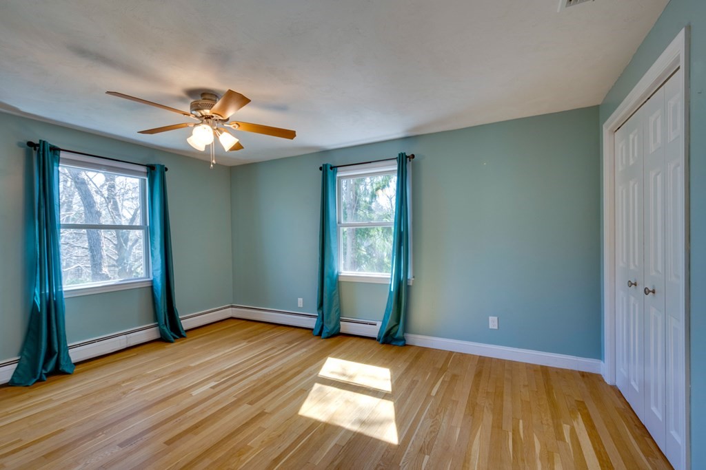 14 Highgate Street Needham, MA 02492 - Photo 20 of 27 an empty room with wooden floor chandelier fan and windows