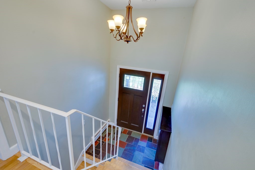 14 Highgate Street Needham, MA 02492 - Photo 4 of 27 a view of a hallway with wooden floor and chandelier