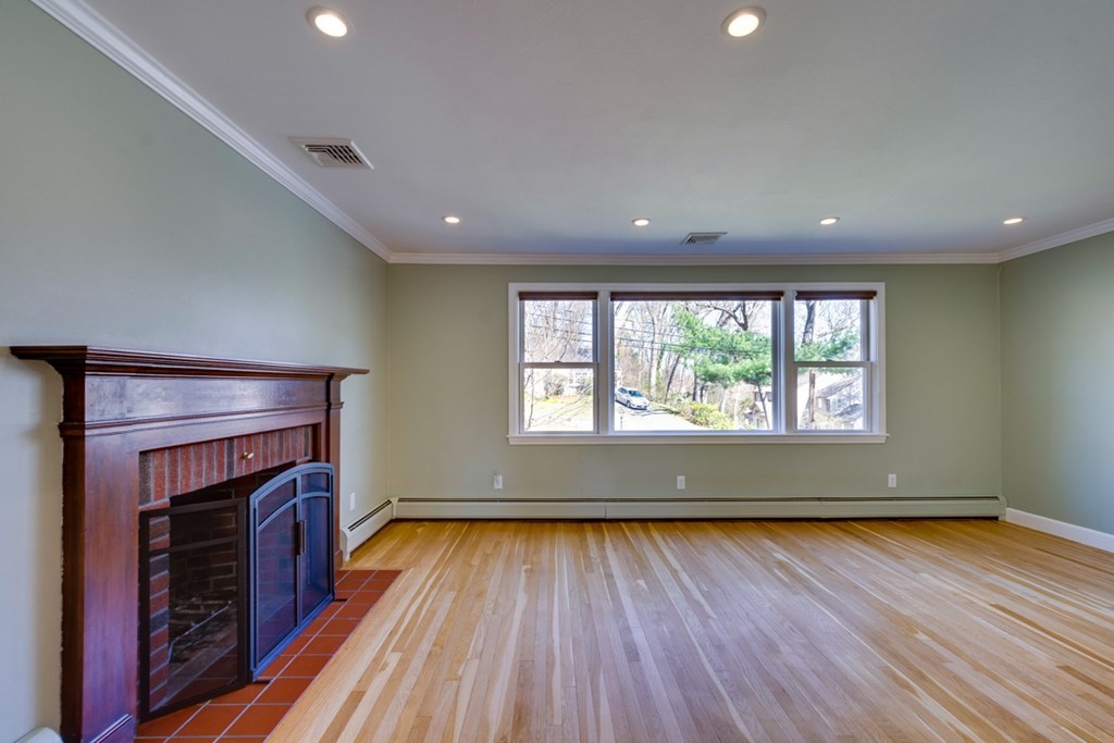 14 Highgate Street Needham, MA 02492 - Photo 6 of 27 an empty room with wooden floor and a window