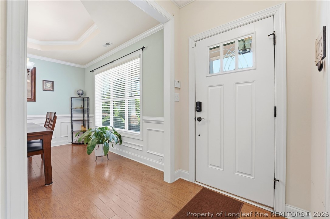 886 Micahs Way North Spring Lake, NC 28390 - Photo 3 of 50 a view of an entryway with wooden floor and a bookshelf