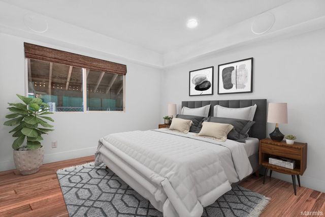 a bedroom with a bed and a painting on the wall