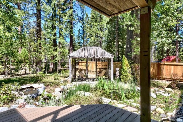 a backyard of a house with lots of green space and fountain