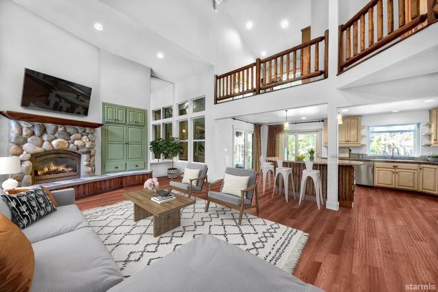a living room with fireplace furniture and a flat screen tv