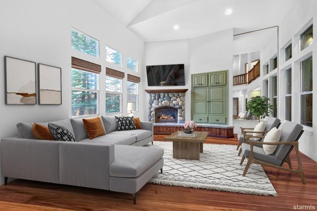 a living room with fireplace furniture and a large window