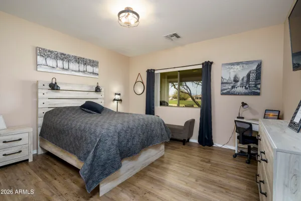 a bedroom with a bed and a desk