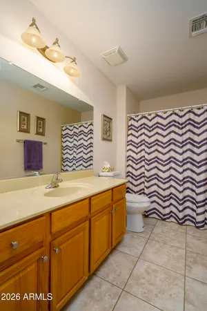 a bathroom with a sink a mirror and a lamp