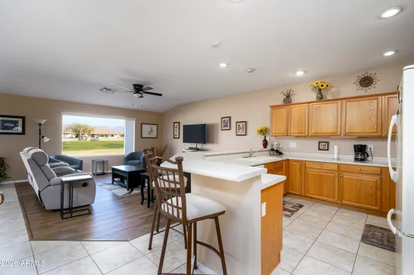 a view of kitchen with cabinets table and chairs