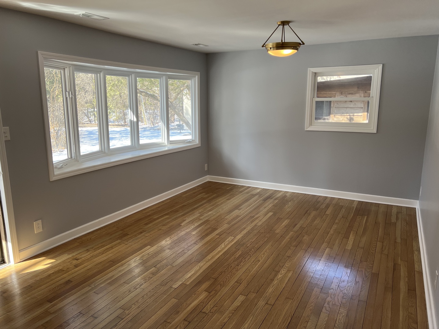 5S511 Radcliff Road Naperville, IL 60563 - Photo 2 of 13 a view of an empty room with wooden floor and a window