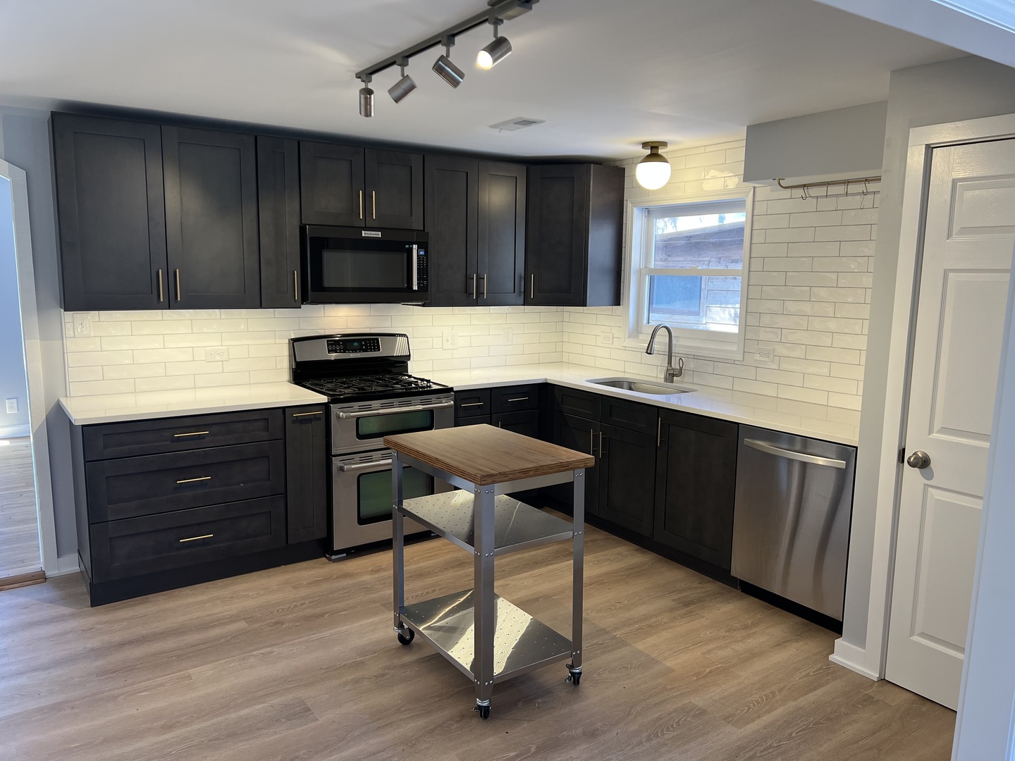5S511 Radcliff Road Naperville, IL 60563 - Photo 3 of 13 a kitchen with a sink a stove a refrigerator and cabinets