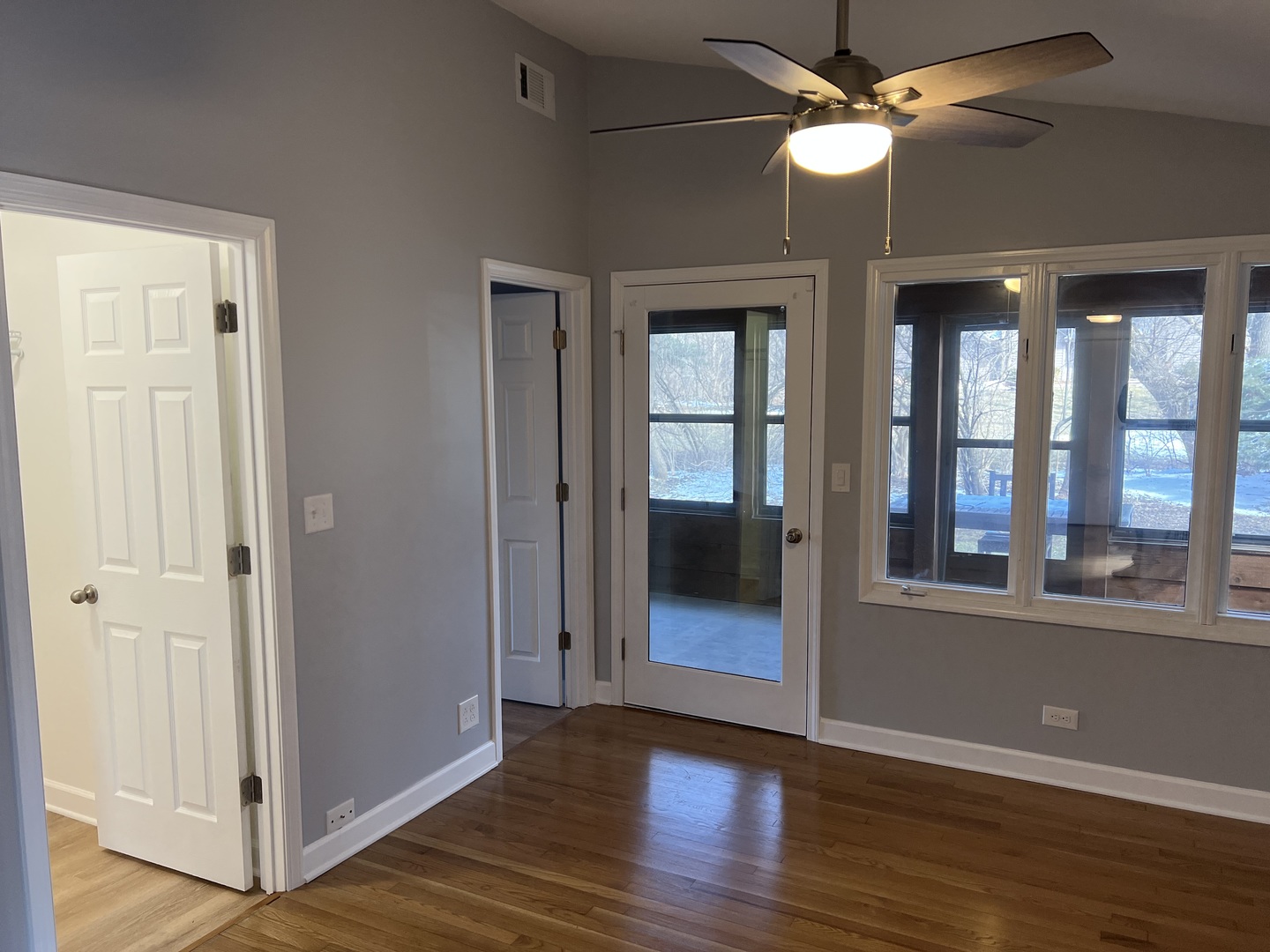 5S511 Radcliff Road Naperville, IL 60563 - Photo 9 of 13 an empty room with wooden floor fan and windows